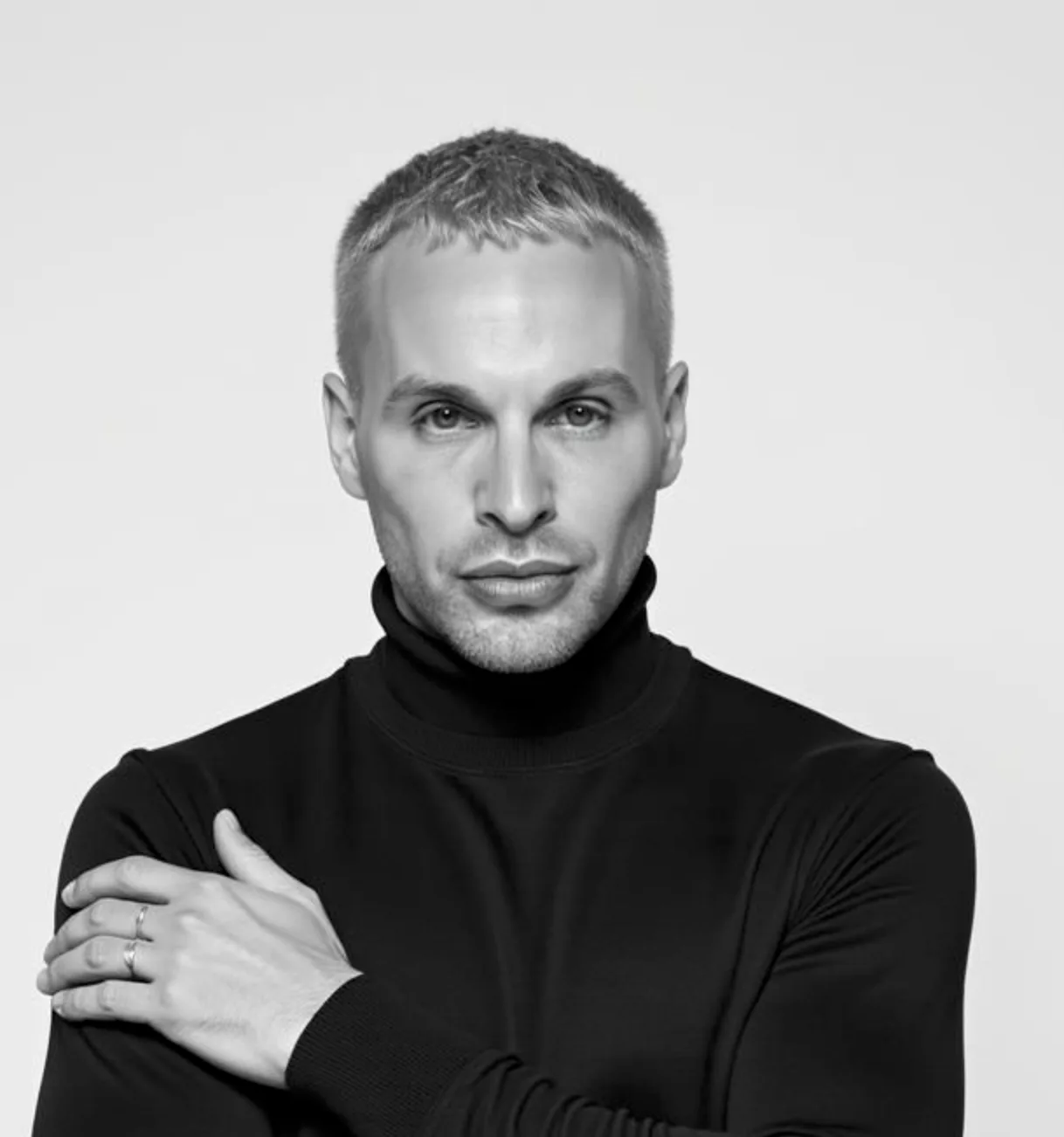 Black and white portrait of Samuel Collett in a black roll-neck.